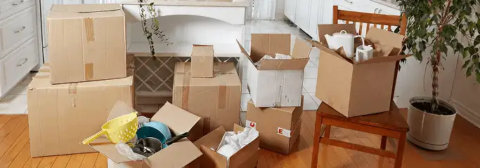 Packed moving boxes and household items in a kitchen before move-out or move-in cleaning, Sioux Falls, SD.